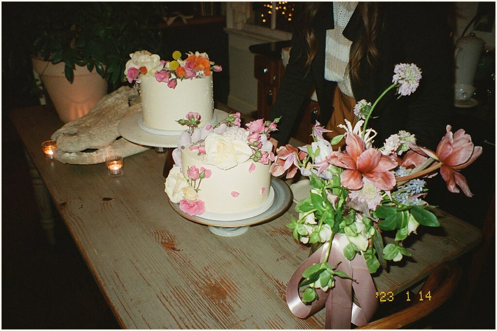 Wedding cakes sit on a long table at a Mosquito Supper Club wedding.