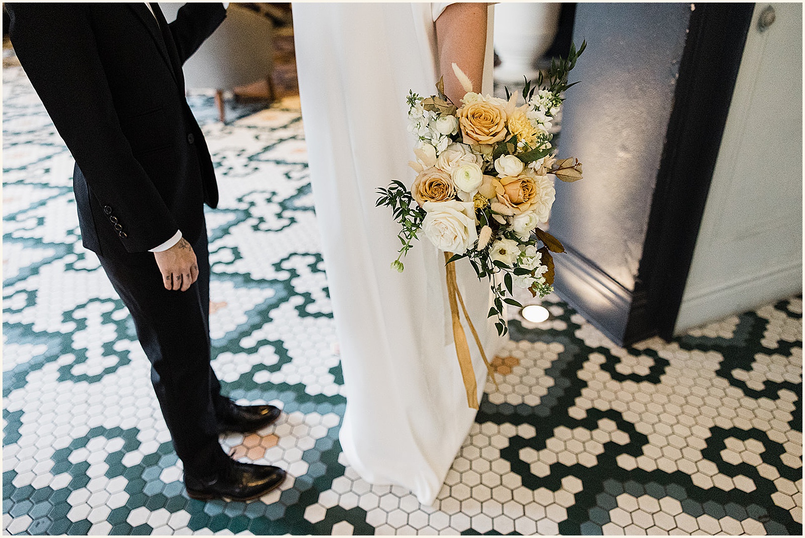 A couple in wedding attire stands in the lobby of the New Orleans Athletic Club.