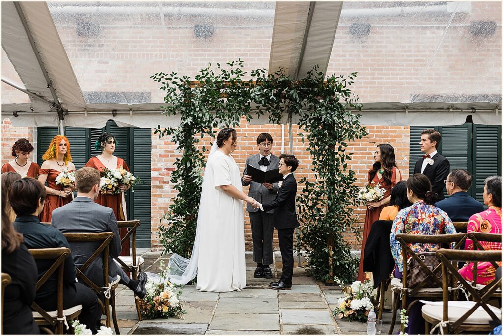 A wedding ceremony takes place in the courtyard of the New Orleans Athletic Club.