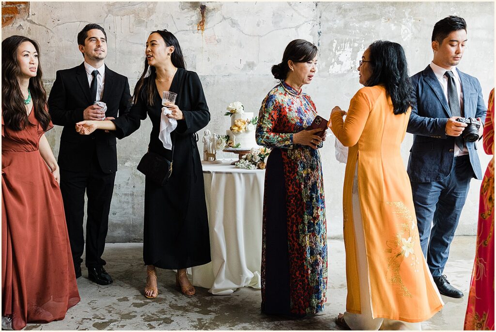 Wedding guests in elegant clothes drink cocktails.