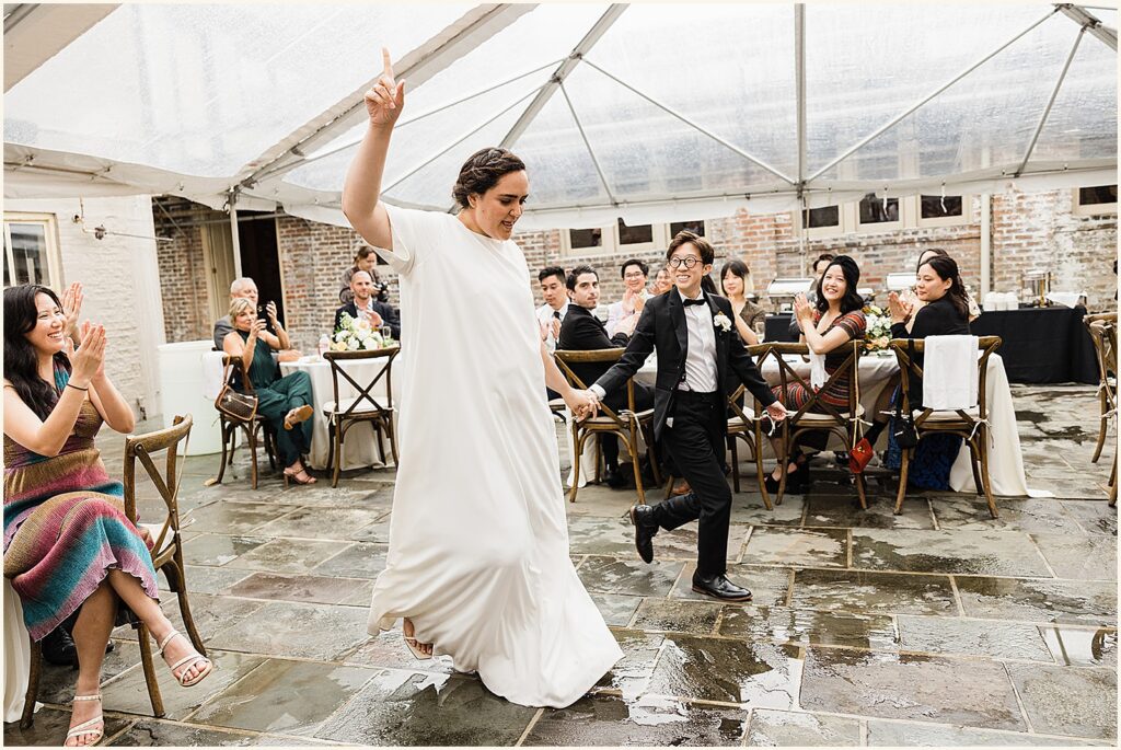 Two marriers enter a tent for their New Orleans wedding reception.