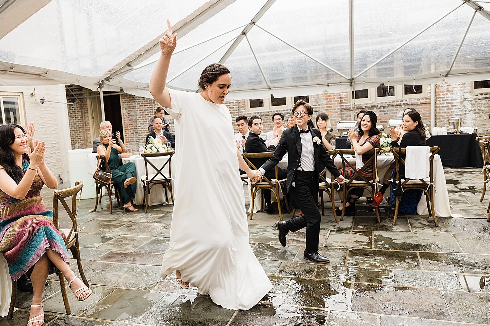 Two marriers enter a tent for their New Orleans wedding reception.