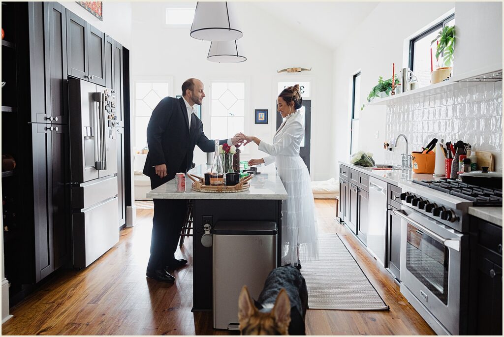 A bride shows a groom her ring in their kitchen in New Orleans.