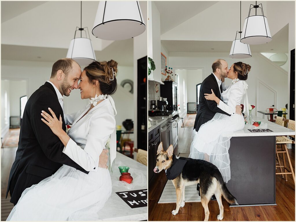 A bride sits on a kitchen counter and kisses a groom before their backyard wedding.