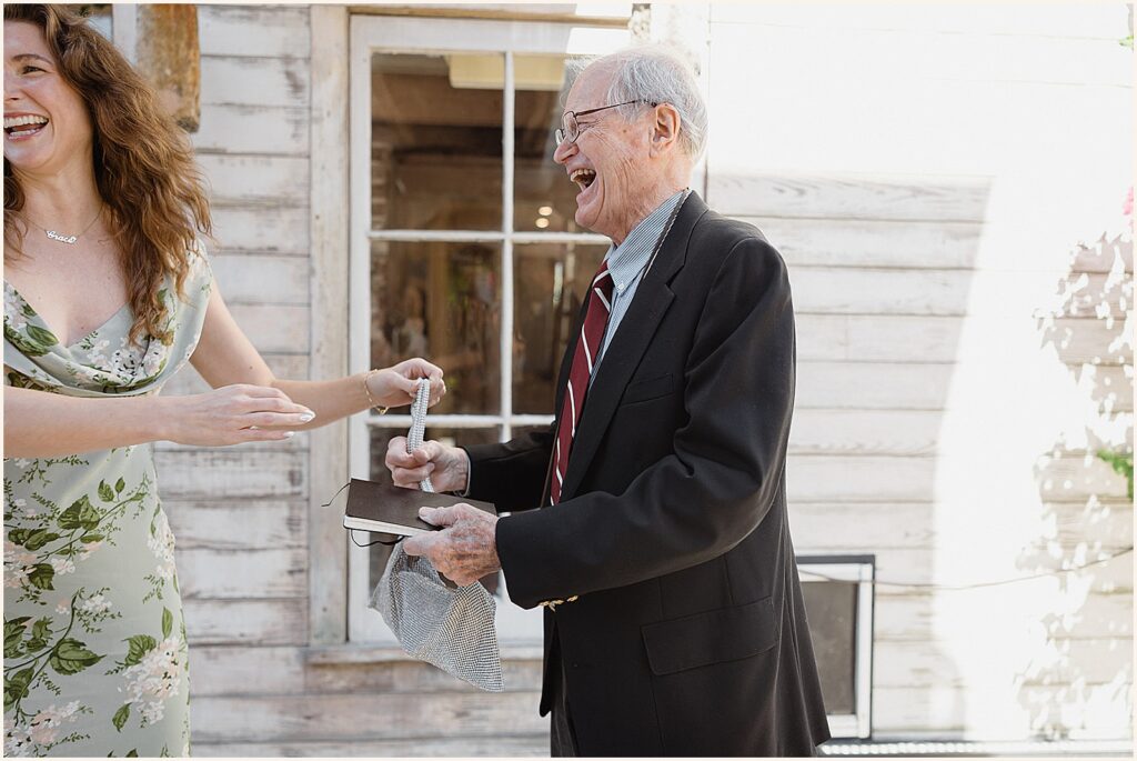 Wedding guests laugh outside a New Orleans wedding venue.