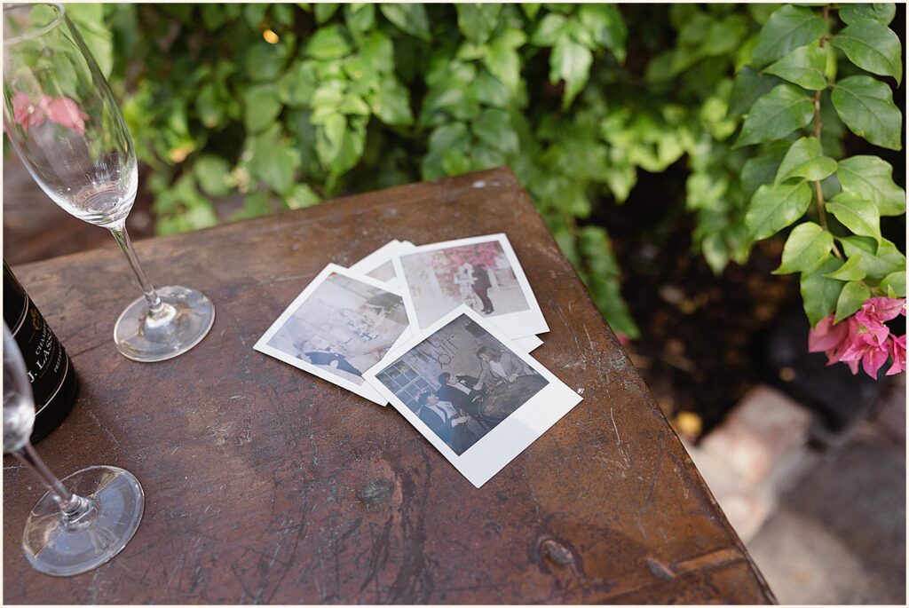 Polaroid photos of a New Orleans elopement sit on a table.