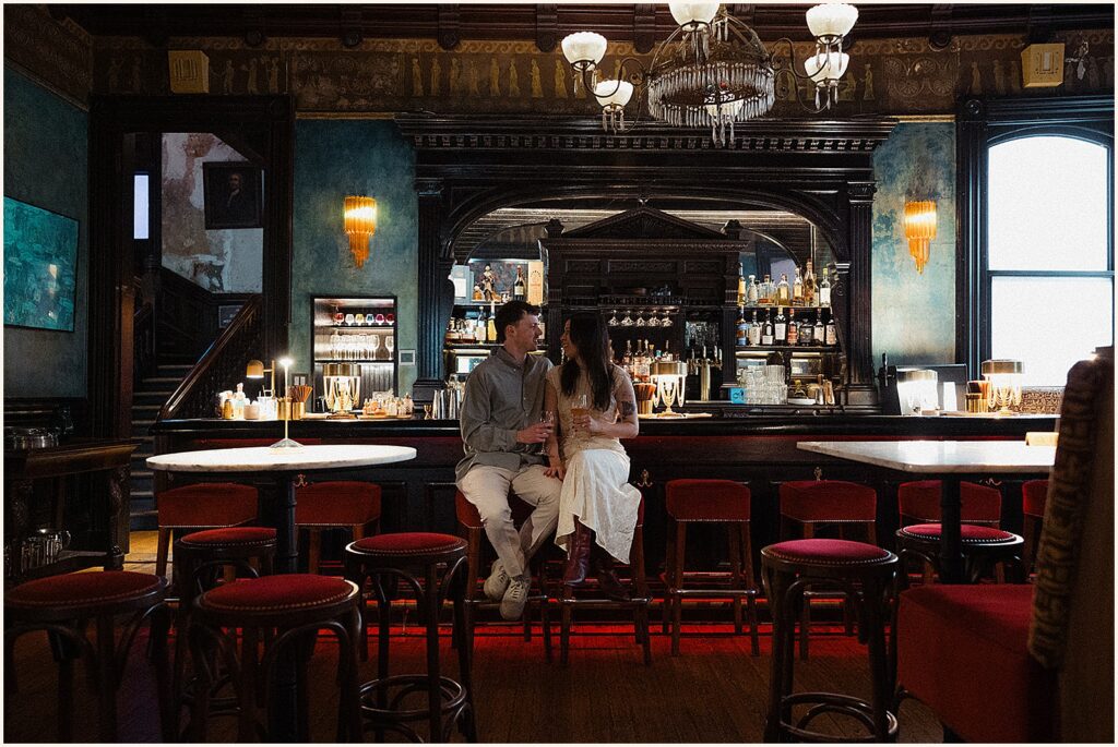 A man and woman lean against a bar in a New Orleans hotel.
