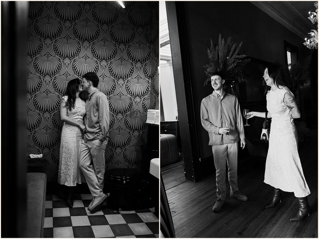 A man and woman lean against a wallpapered wall in the Columns Hotel.